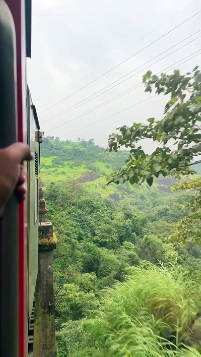 Passing over a viaduct while climbing through the Kasara Ghats in midst of a beautiful sunset and spotting WAG7 bankers on the opposite track.  Wait for the screeching track sounds towards the end!