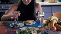 Girl-eating-salad-in-her-kitchen-dining-room