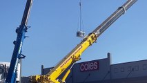 A crane lifts a crate over Wagga's Sturt Mall on Tuesday afternoon after the shopping precinct was unexpectedly closed earlier in the day due to a water pipe leak.