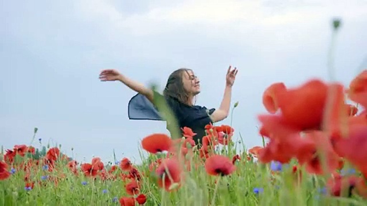 girl-dancing-happily-in-a-field-of-flowers