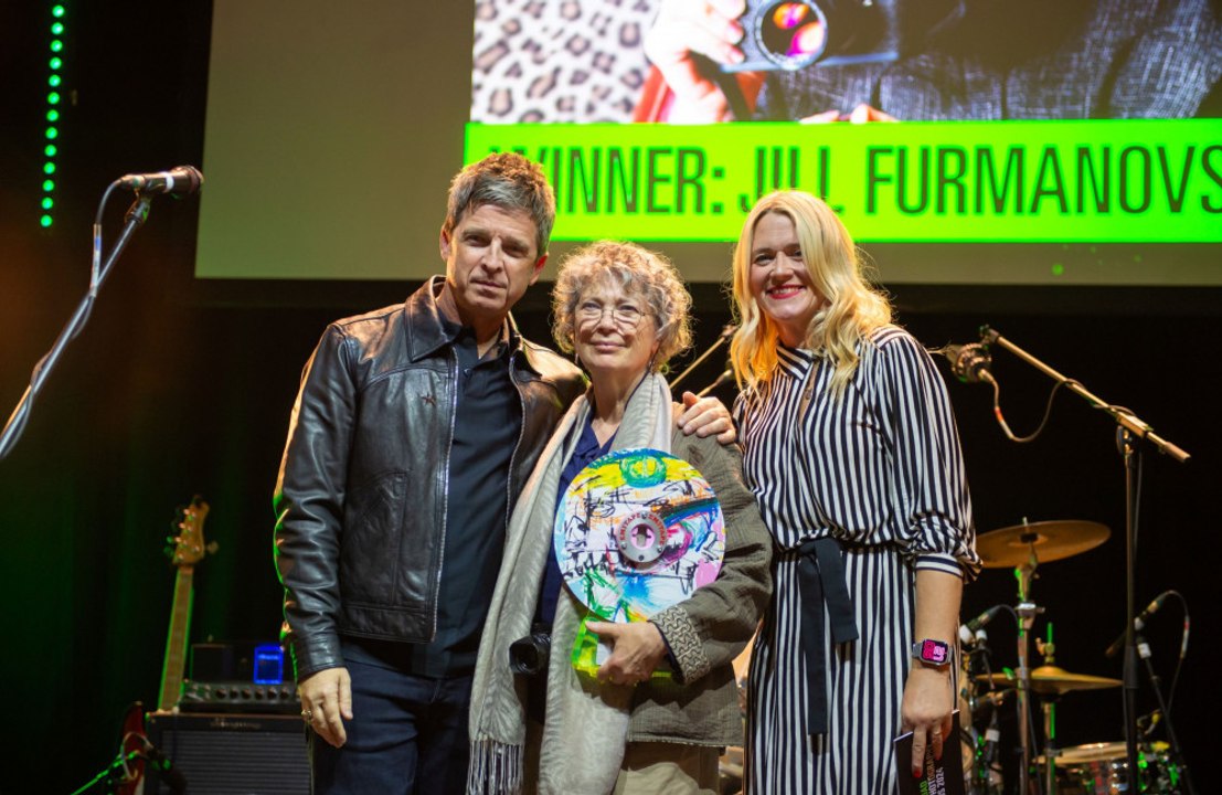 Noel Gallagher surprises  long-time Oasis photographer Jill Furmanovsky with an ICON Award at Abbey Road Music Photography Awards