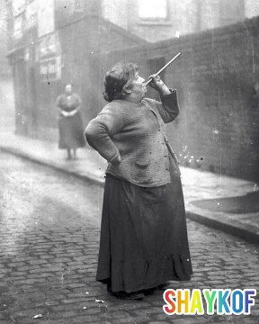 A female wake-up caller wakes workers up for their shift. 1940-1950, UK.