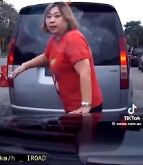Woman jumps in front of car to help husband cut into traffic