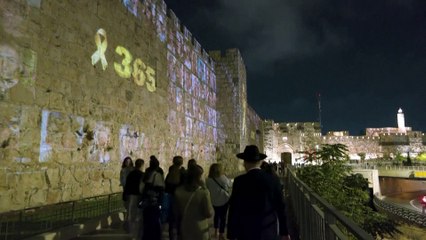 Oct. 7 hostage images light up Jerusalem on anniversary eve