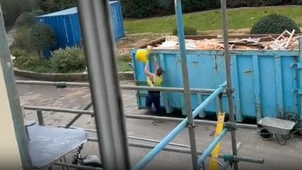 Construction worker ends up being covered in garbage while trying to clean up