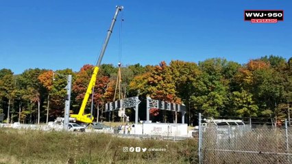 Crews remove overhead freeway sign damaged by gravel hauler on I-96
