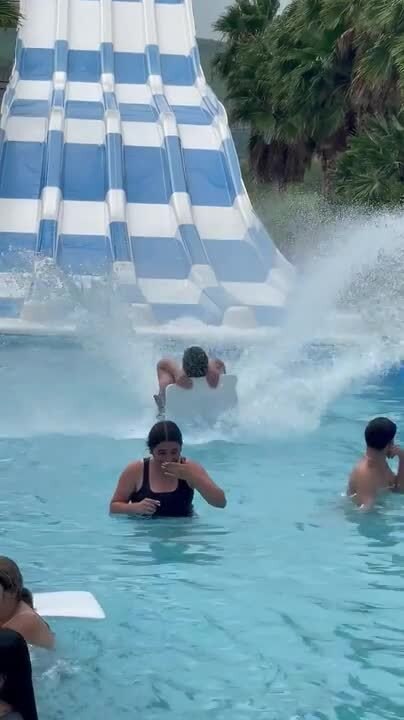 Man Sliding Down From Water Slide Crashes Into Woman In Pool