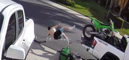 Man Falls off Pickup Truck While Unloading Dirt Bike