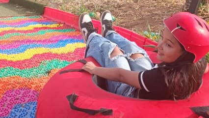 Girl going on a slide fails to maintain her balance in the end *Hilarious*