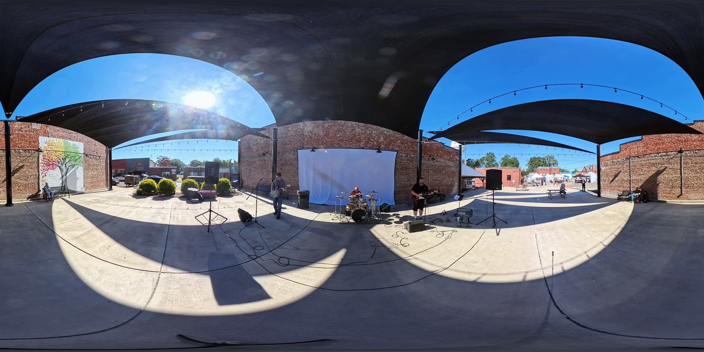 Faded 360 Bastet in traditional Ancient Egyptian attire walking in a massive torch lit chamber inside a pyramid or temple. Cut to a tight show of her eyes decorated with blue eye shadow and black eye liner.