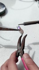 Jewelry maker is creating a soft solder rose quartz pendant with spikes!