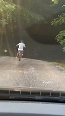 Kid is racing his dad down the hill and almost loses control of his bike!