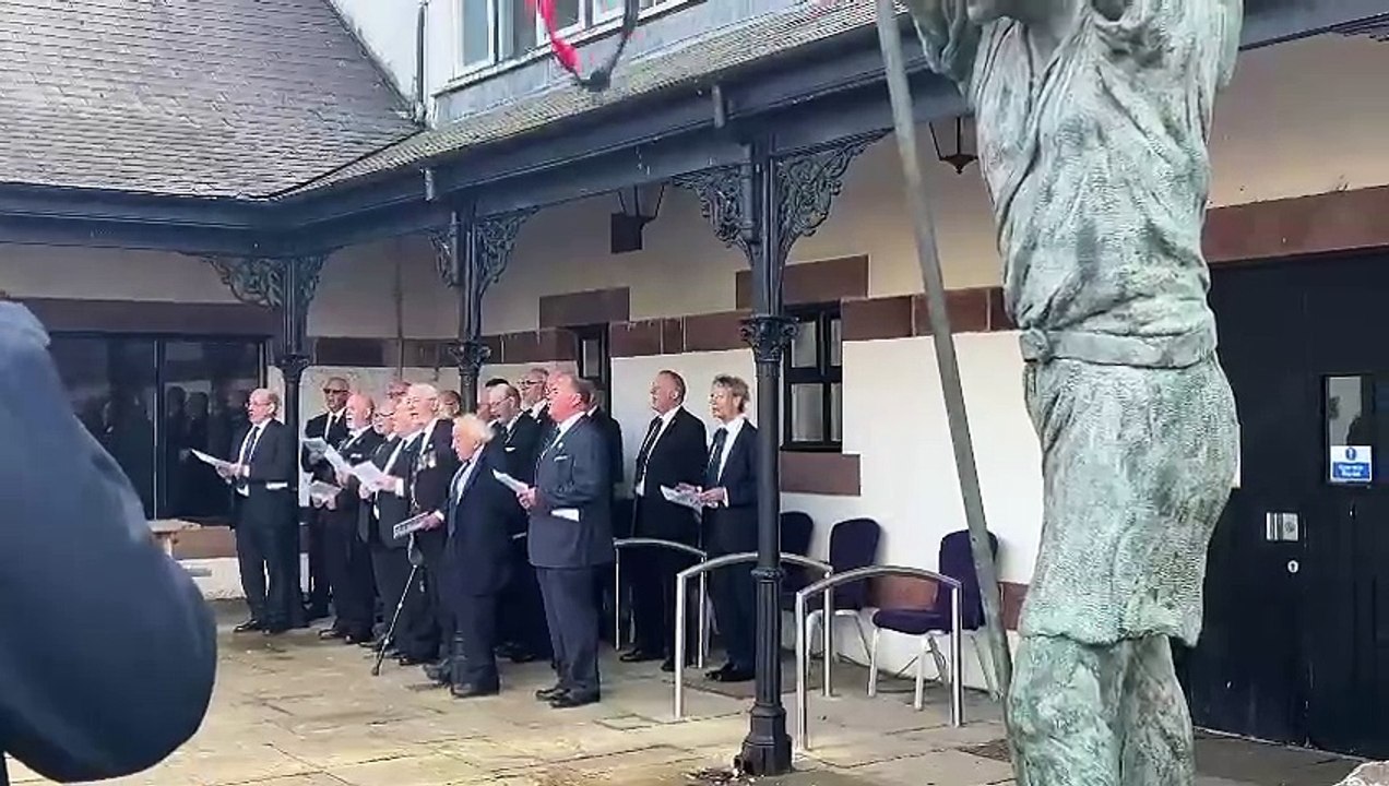 Choir sings a sea shanty for Princess Anne outside House of Manannan