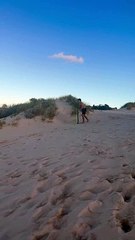 Guy Slides Down Massive Sundune And Skims Across Water!