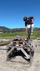 Man on Unicycle Makes Jump Onto Pile of Wooden Pallets