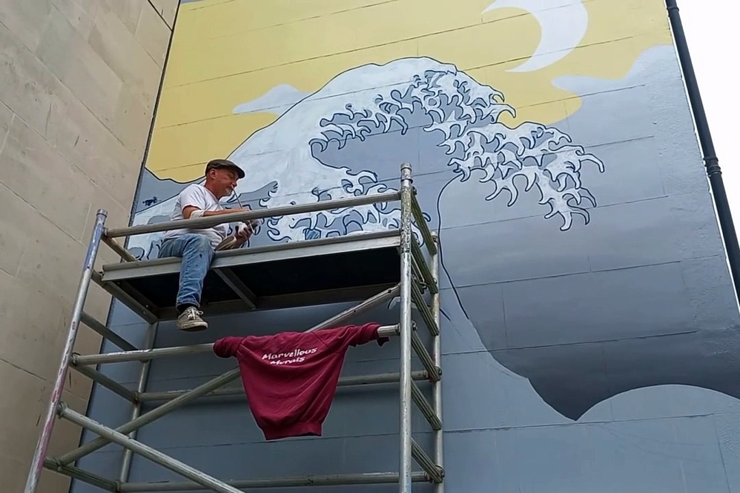 Aberystwyth's Bookshop by the Sea mural being painted by Dean Tweedy