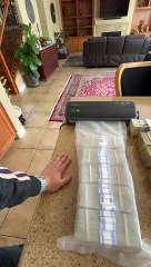 Person is vacuum sealing a large amount of money!