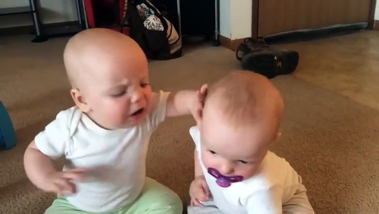 Twin baby girls fight over pacifier
