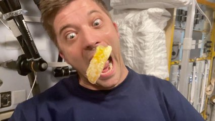 Slow Motion Video:  Captures Astronaut Eating A Slice Of Orange In Space Station