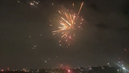 A beautiful glimpse of the New Year fireworks from a rooftop