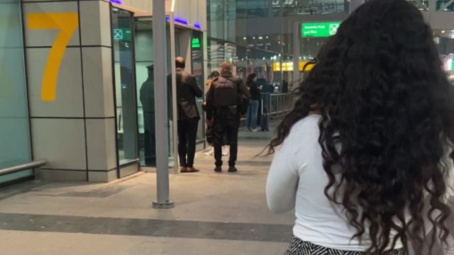 Straight strands and buoyant curls embrace in airport light