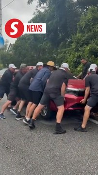 Strength in numbers: Bus passengers lift cars to clear road