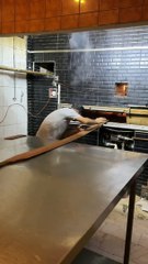 The lines of bread this man pulls out of the oven