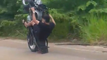 Avid biker fumbles a wheelie and then faces a collision with fellow rider