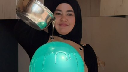 Girl pours water over a balloon and faces an unexpected loud burst