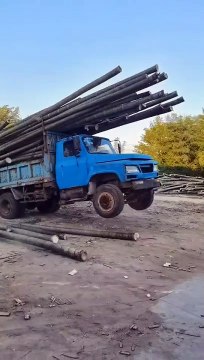 Dump truck dumping bamboo