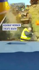 Shocking moment highway worker narrowly cheats death during high speed collision