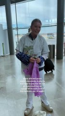 Girl is putting on several layers of clothing to make her bag smaller!