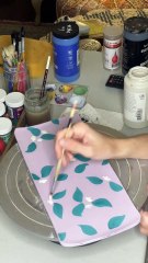 Artist is painting and carving a ceramic dish!