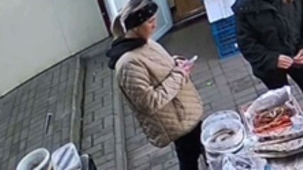 Girl at market drops phone into herring container, quick recovery follows