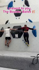 Two people are climbing the Buddy Boulder route at a climbing gym!