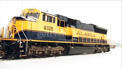A man enters a train engine as it snows. - HD stock videogettyimages-1192484161-640_adpp