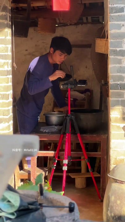 Mr. Lu is busy in the kitchen.