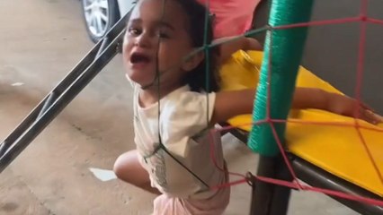 Fun turns chaotic: Little girl gets tangled in bouncy castle netting