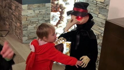 Curious toddler acts silly around creepy Halloween characters without fear