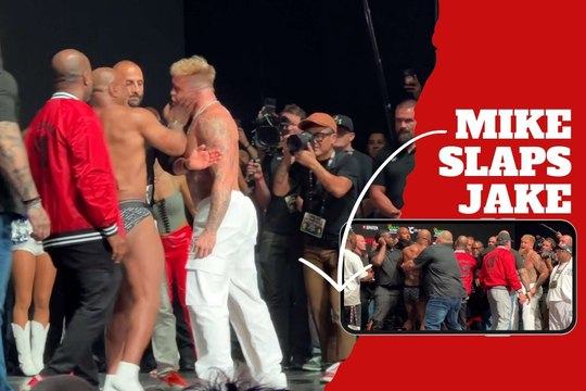 Mike Tyson surprises Jake Paul with a slap in the face as he comes face to face with him at the weigh-in