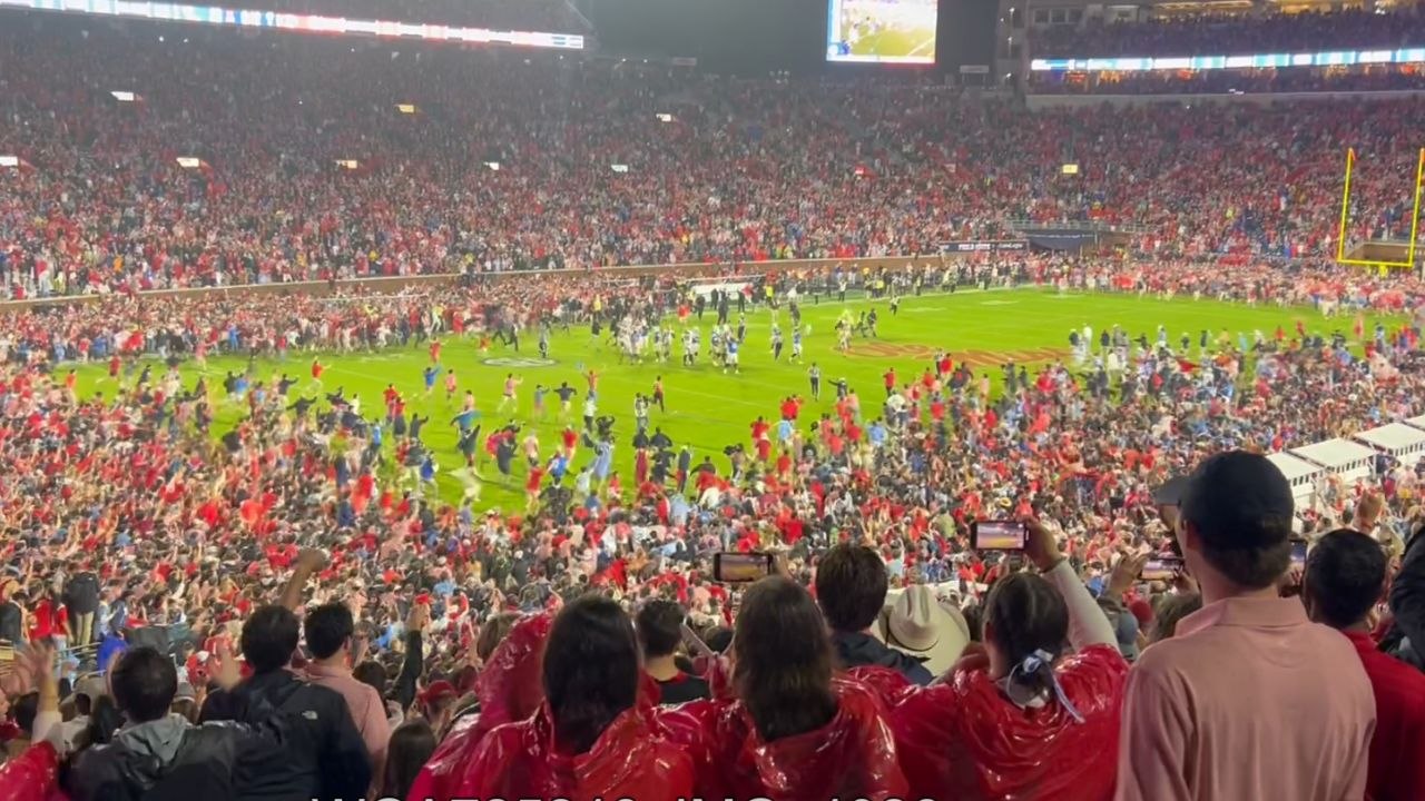 Ole Miss fans take over the field in jubilant celebration after beating Georgia Bulldogs