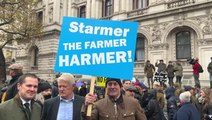 Robert Jenrick poses under ‘Starmer the farmer harmer’ sign at ‘tractor tax’ protest