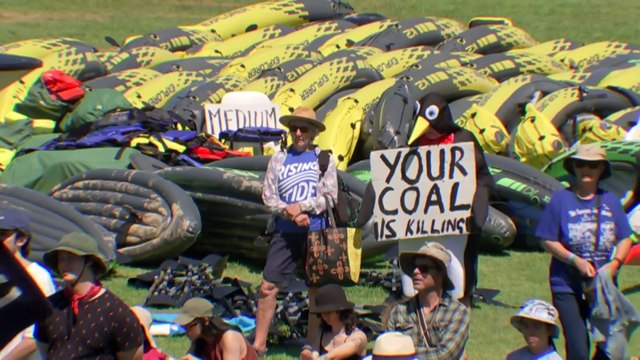 Climate protesters gather on Newcastle beach to protest coal exports after a NSW supreme court ruling
