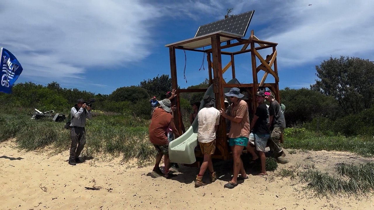 Protesters carry a pontoon onto the beach ahead of the flotilla launch in Newcastle  Newcastle Herald | November 22, 2024