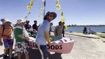 Rising Tide protesters carry their boat through a police line during harbour action in Newcastle | Newcastle Herald | November 22, 2024
