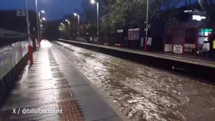 Floodwaters gush down tracks of Walsden Station