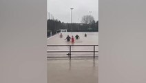Footballers turn flooded Gloucestershire pitch into swimming pool