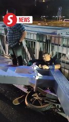 Motorcyclist crushed by fallen barrier, survives with broken hand in KL