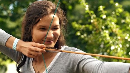Female archer shooting an arrow - Free Stock Video