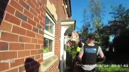Drug dealer dressed only in his boxers jumps on police as they cut through his door with chainsaw